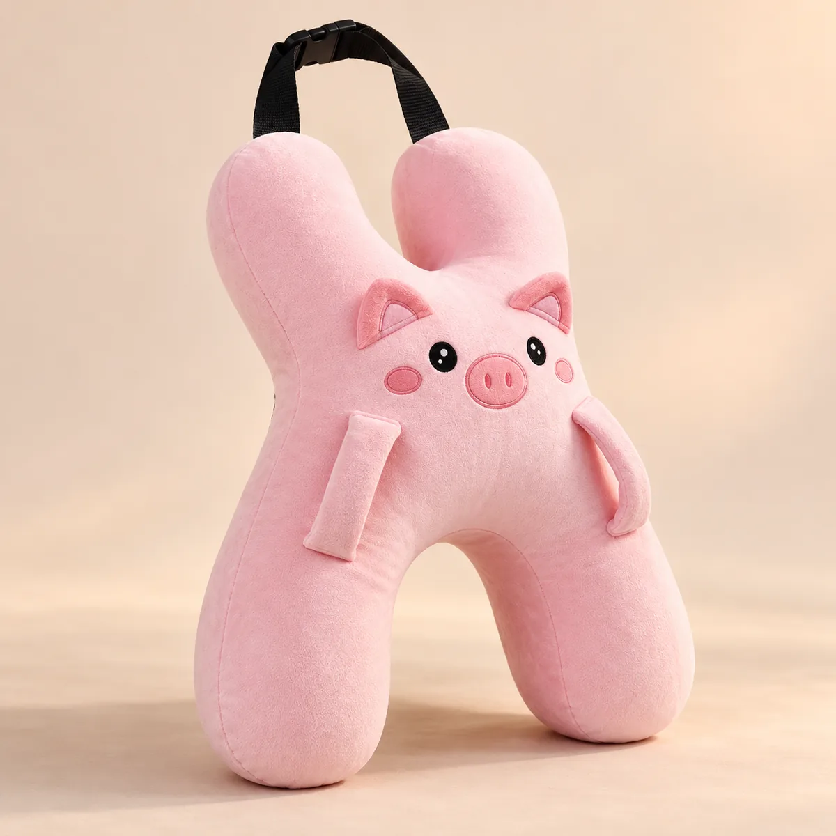Coussin câlin de voiture Cochon rose, vu de trois-quarts, avec sa sangle à boucle
